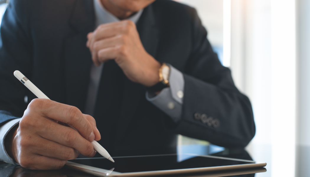 Man signing a digital contract